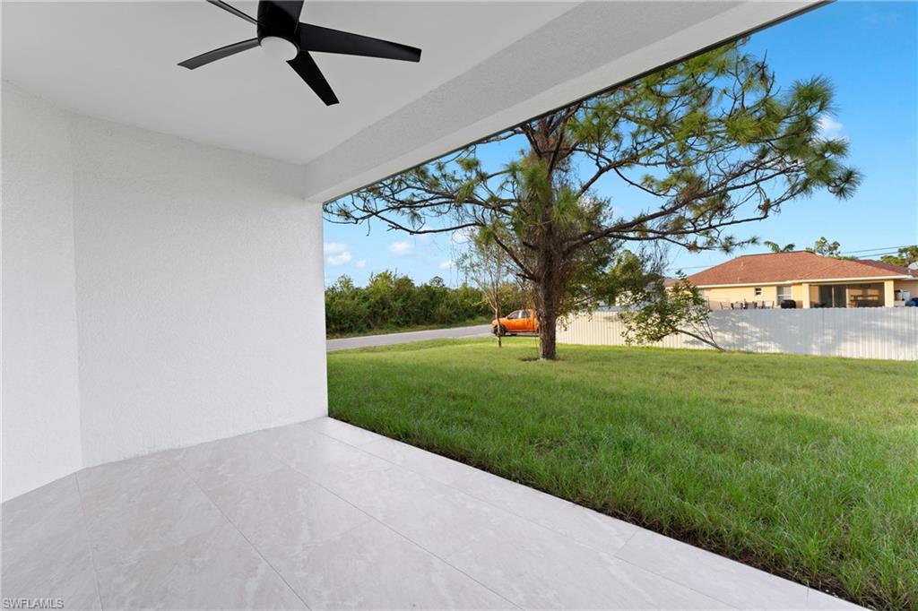 View of yard featuring ceiling fan and a patio area