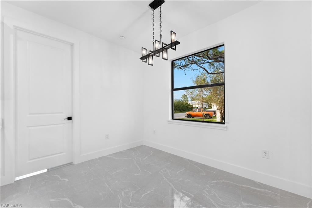 Unfurnished dining area featuring a notable chandelier