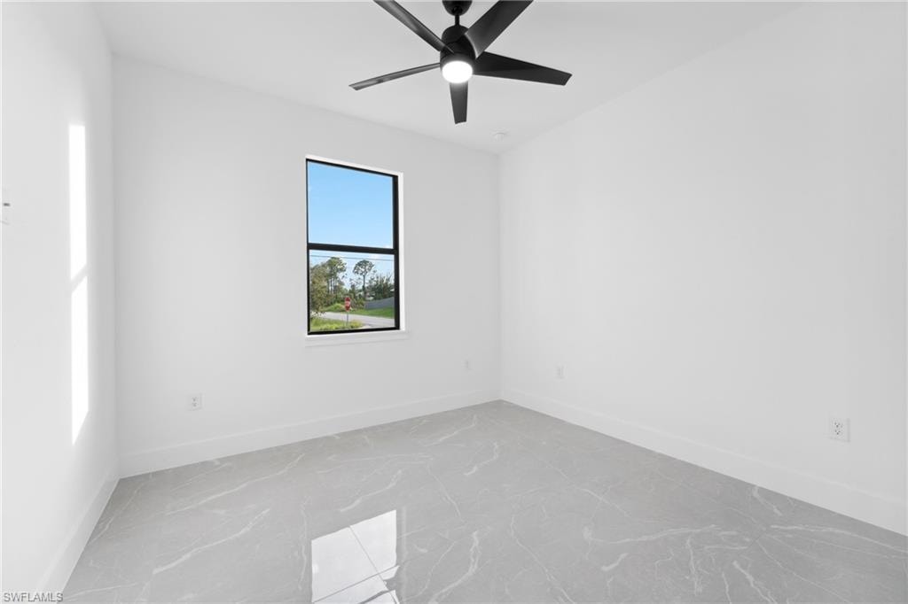 Empty room featuring ceiling fan