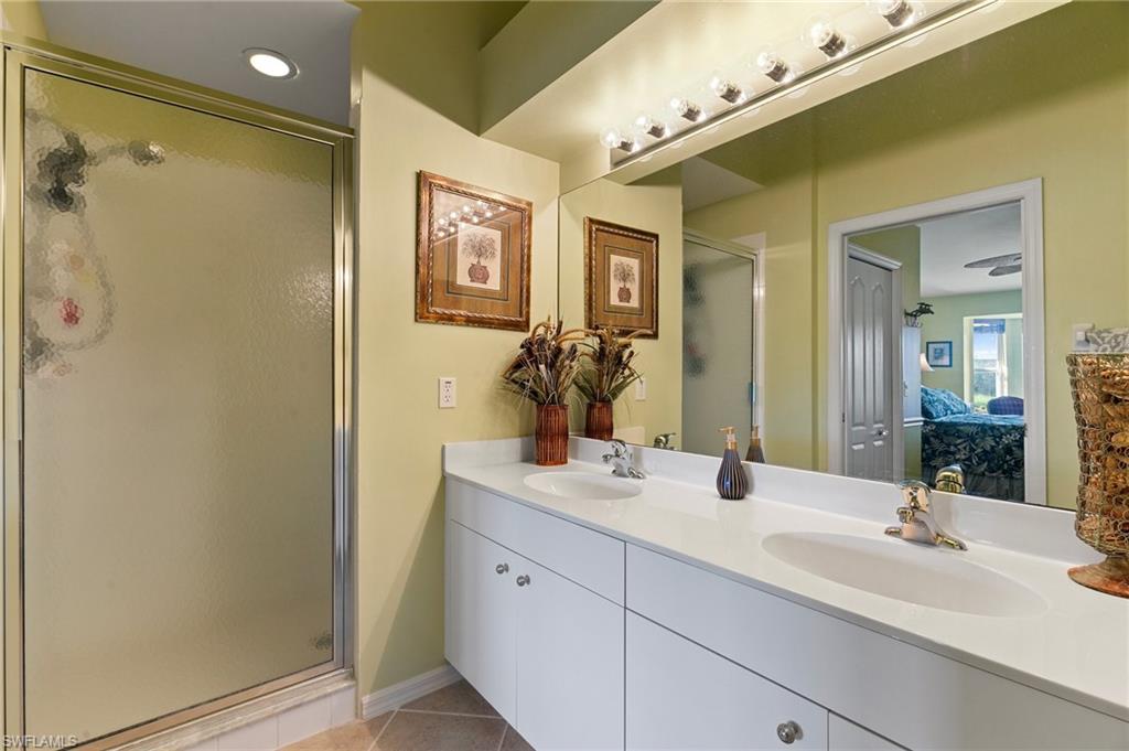 Master bathroom featuring dual vanities and walk-in shower.