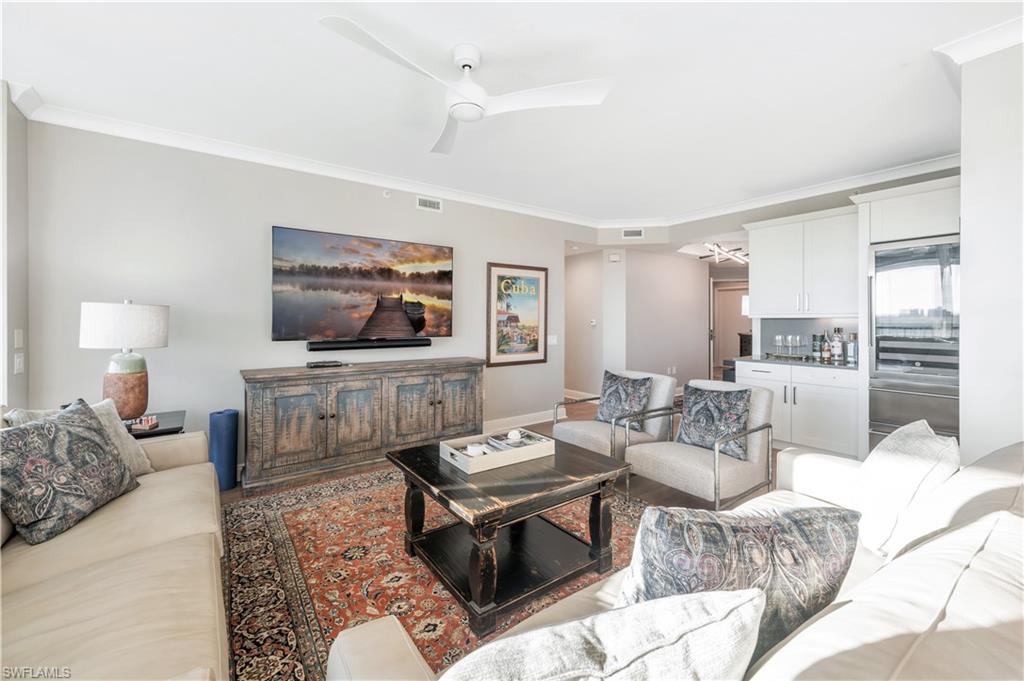 Living room featuring crown molding and ceiling fan