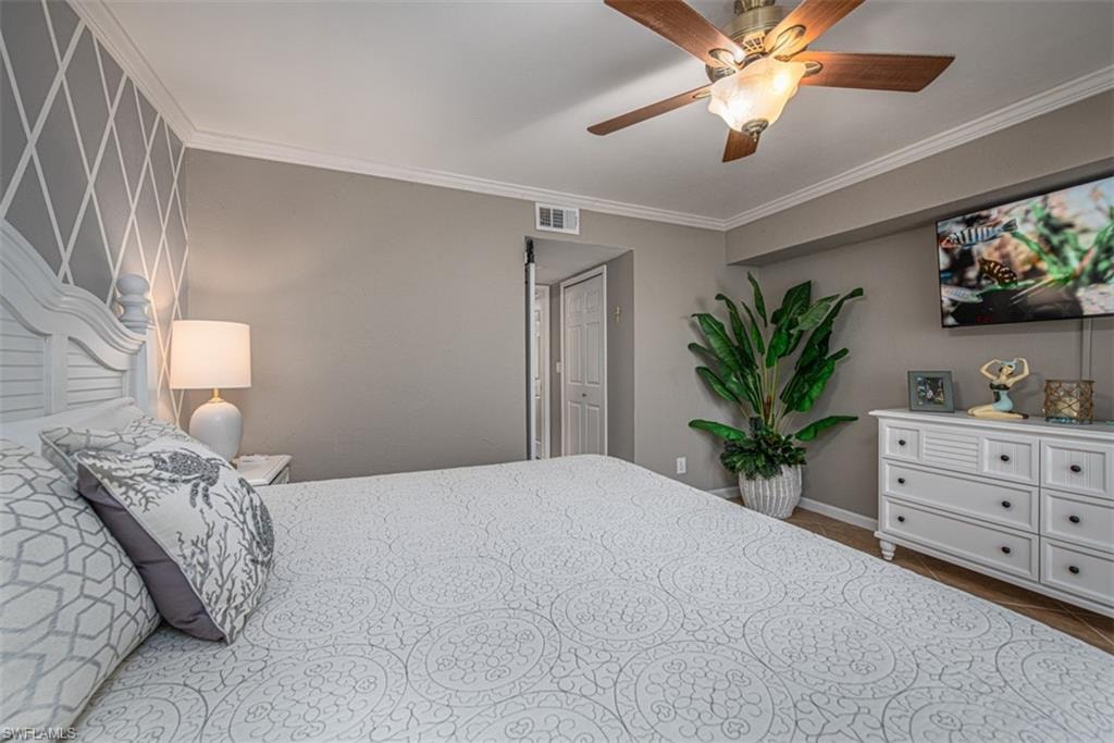 Bedroom with ceiling fan and crown molding