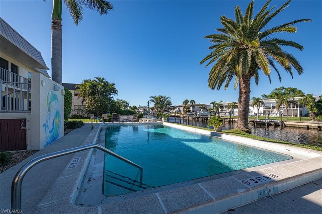 View of pool with a water view