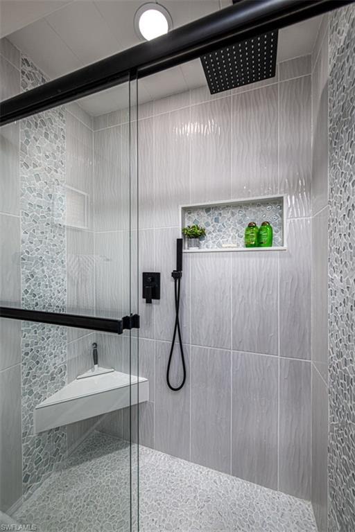 Bathroom featuring a shower with door