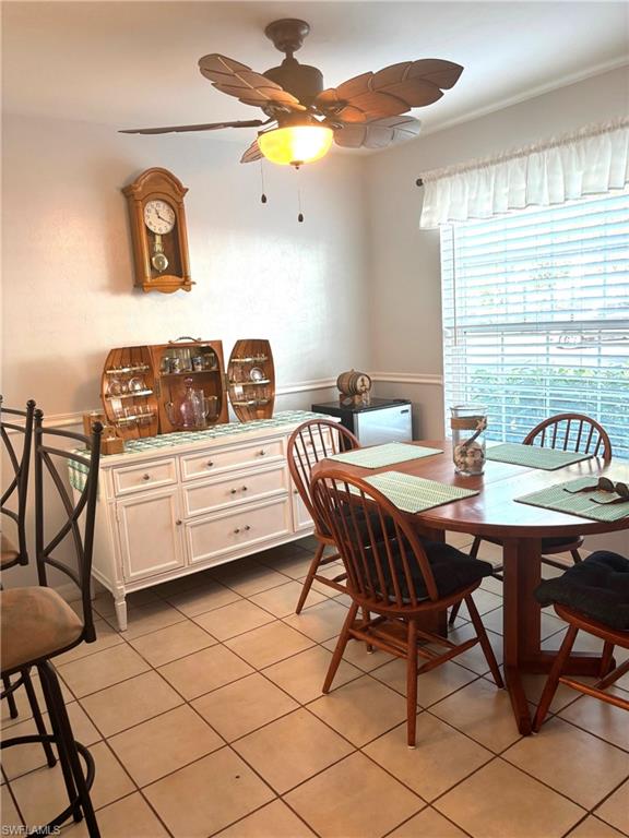 Tiled dining space with ceiling fan