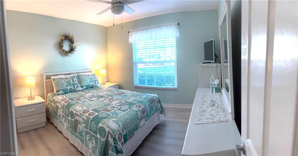 Bedroom with ceiling fan and wood-type flooring