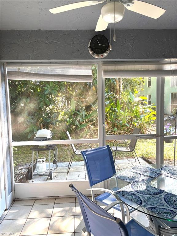 Unfurnished sunroom featuring ceiling fan