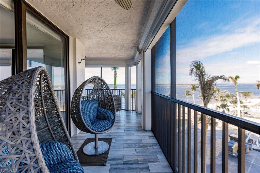 Sunroom / solarium with a water view