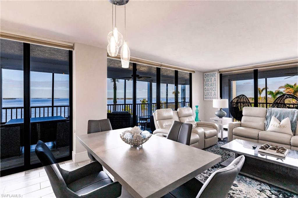 Dining space with floor to ceiling windows, a water view, and a wealth of natural light