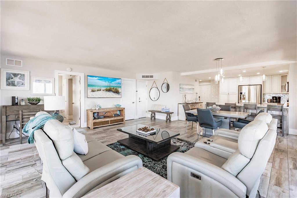 Living room with a chandelier and light hardwood / wood-style floors