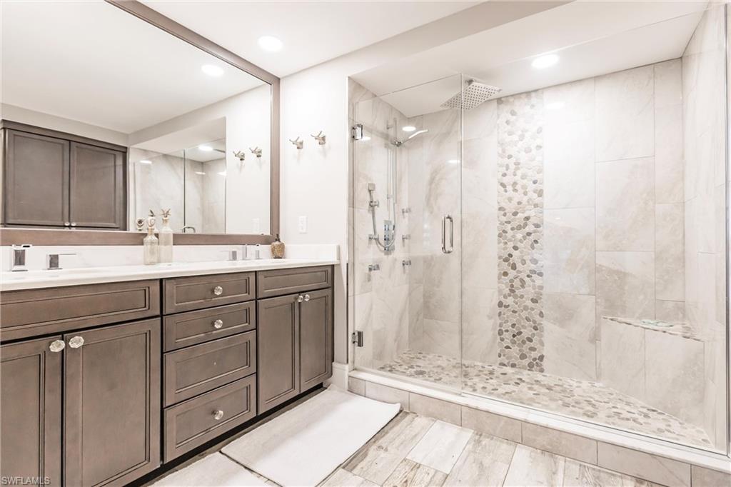 Bathroom with vanity and a shower with door
