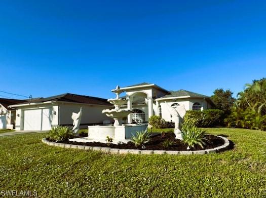 View of front of home with a front yard and a garage
