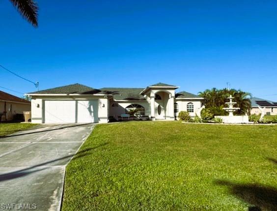 Single story home featuring a garage and a front lawn