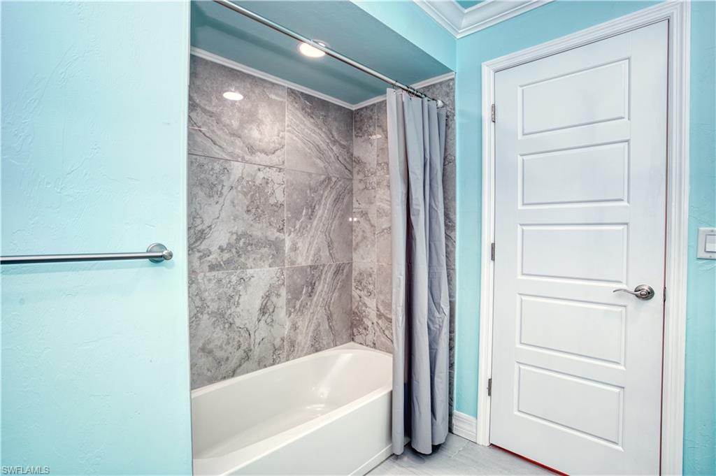 2nd bathroom with tub and access to pool area