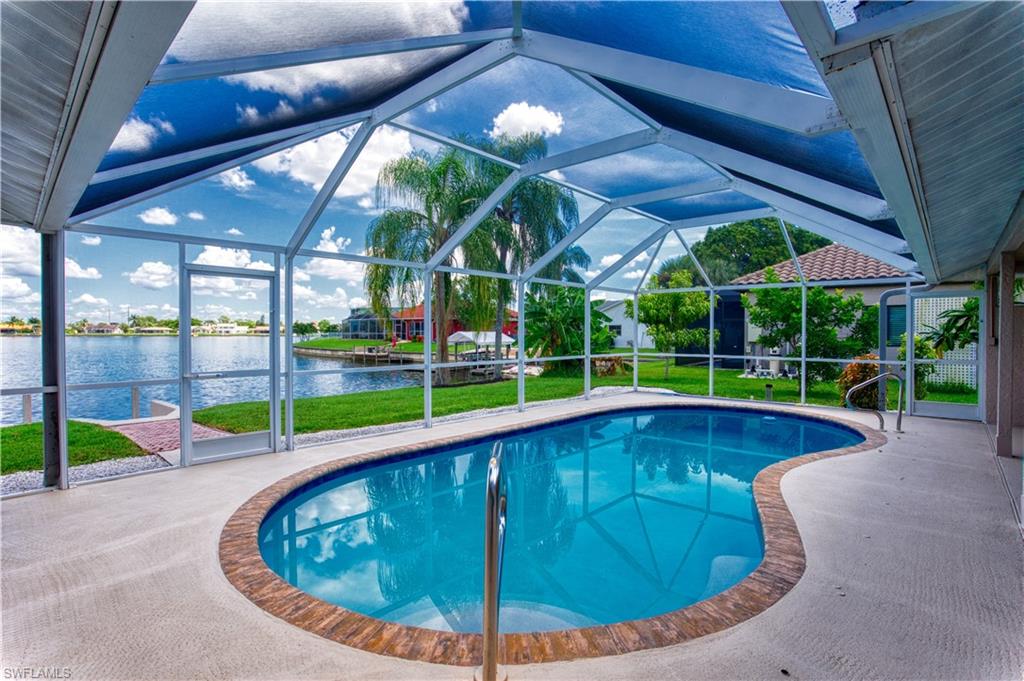 Pool with screen enclosure and views of Lake Kennedy