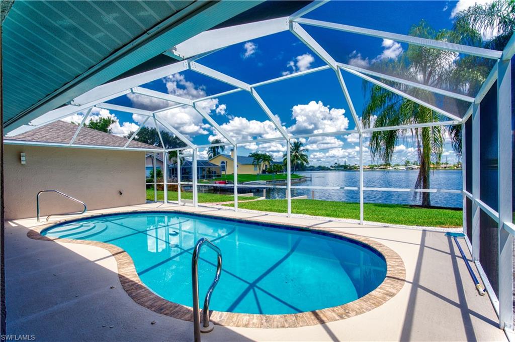 Pool with screen enclosure and views of Lake Kennedy