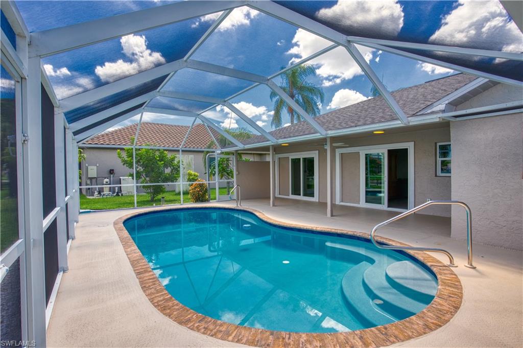 Pool with screen enclosure and views of Lake Kennedy