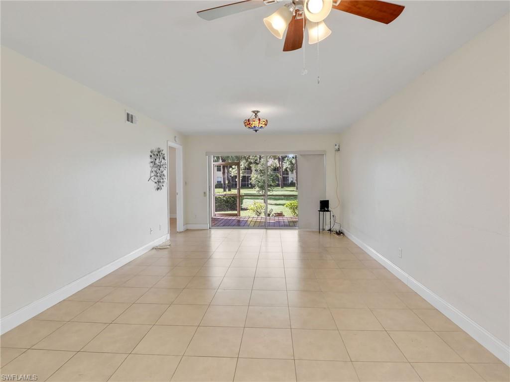Unfurnished room with ceiling fan and light tile patterned flooring