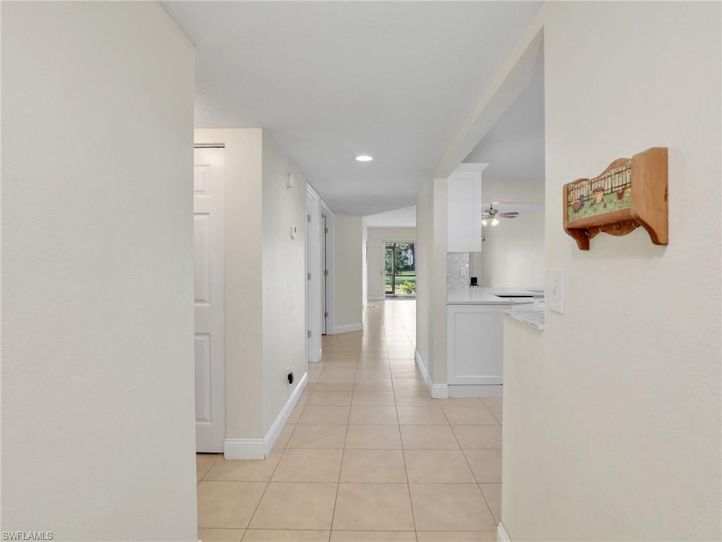 Hall featuring light tile patterned floors