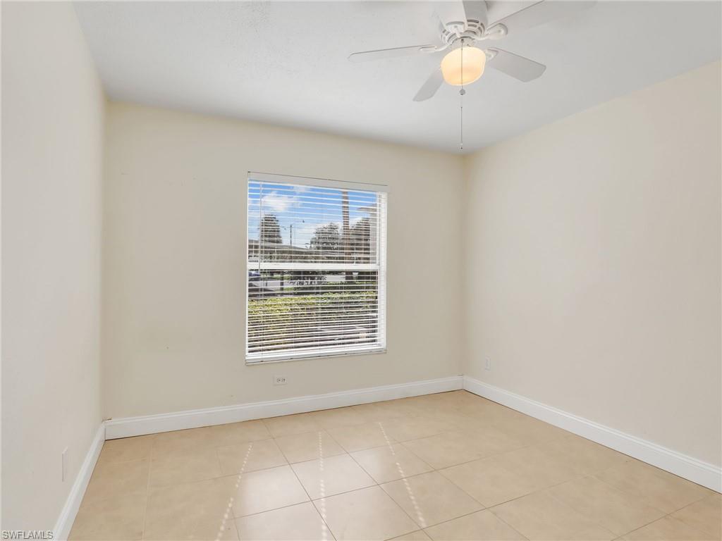 Tiled spare room with ceiling fan