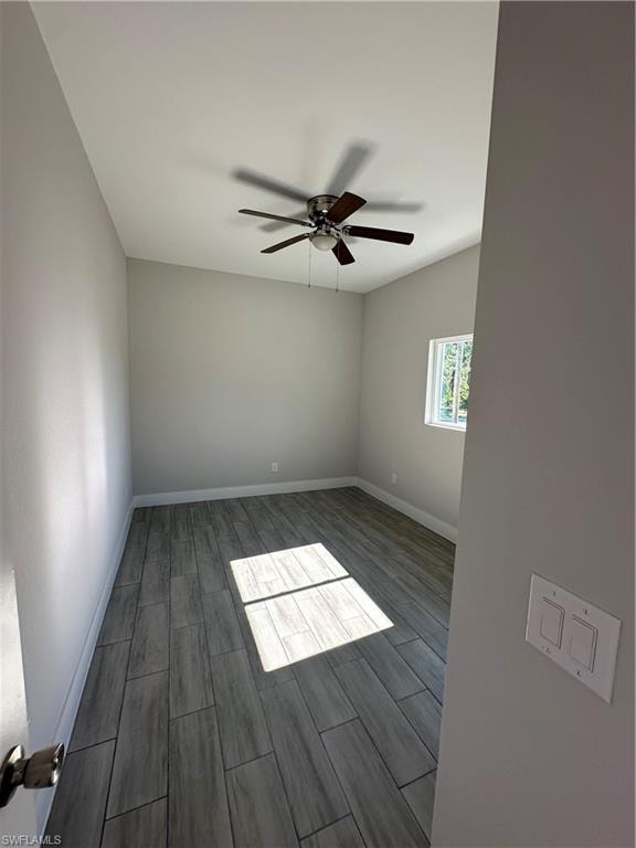 Spare room featuring dark hardwood / wood-style floors and ceiling fan