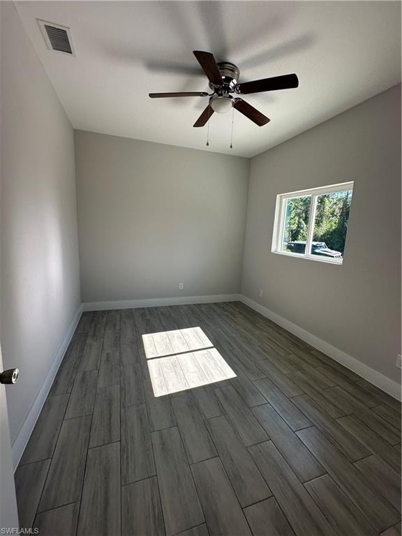 Spare room with hardwood / wood-style flooring and ceiling fan