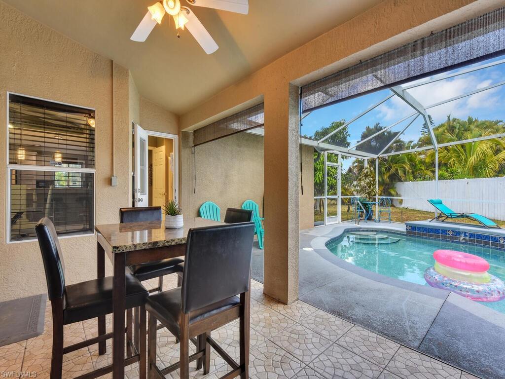 View of pool with ceiling fan, a patio area, a lanai, and a jacuzzi