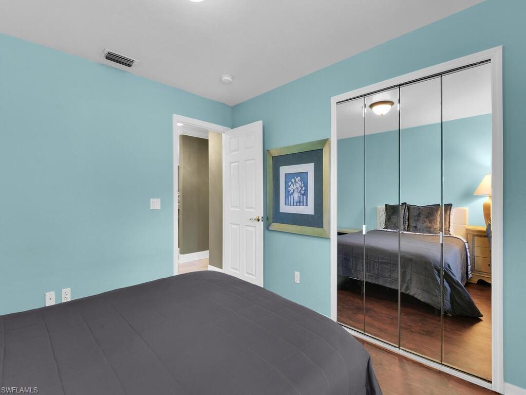 Bedroom with wood-type flooring and a closet