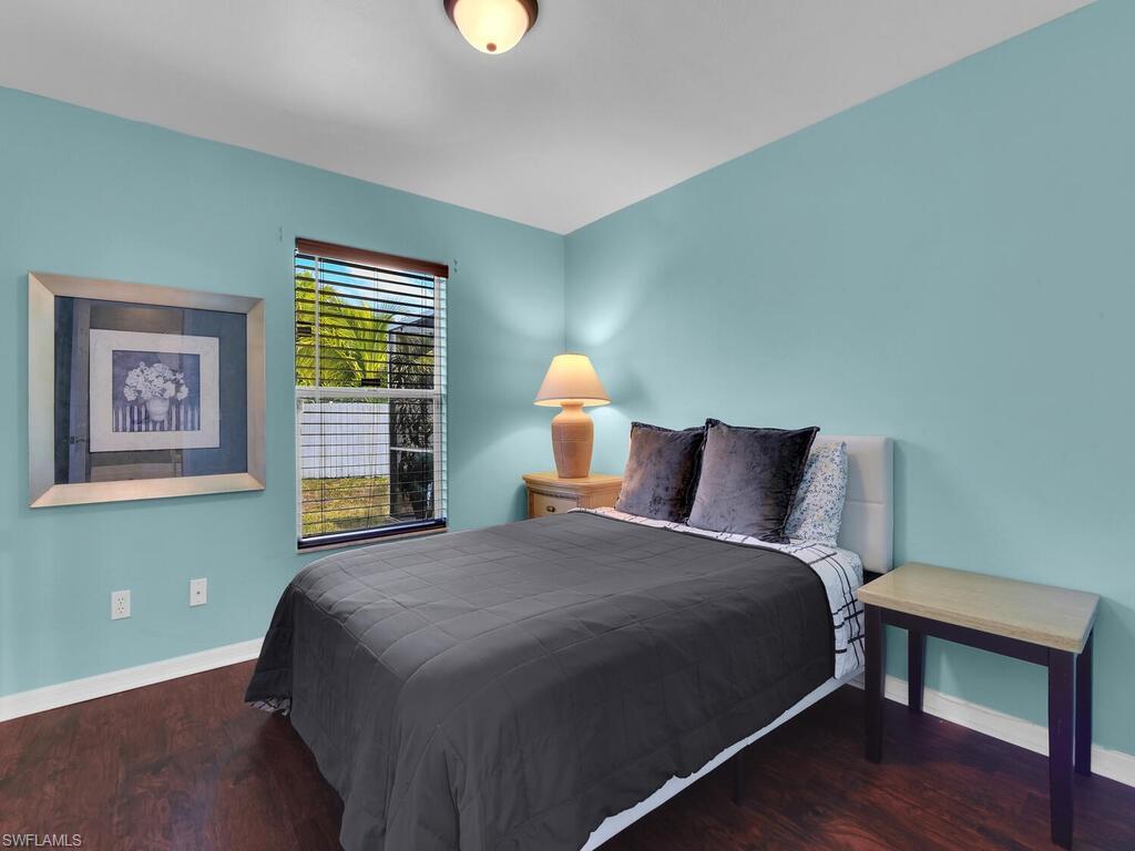 Bedroom with dark hardwood / wood-style floors
