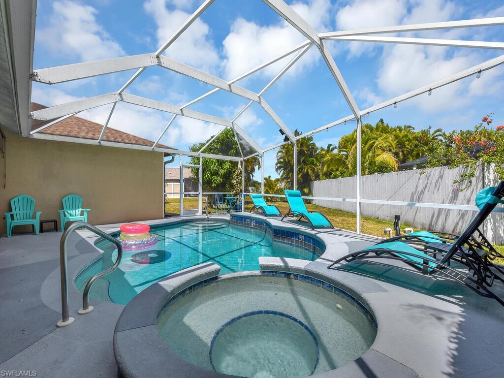 View of swimming pool with a lanai, an in ground hot tub, and a patio