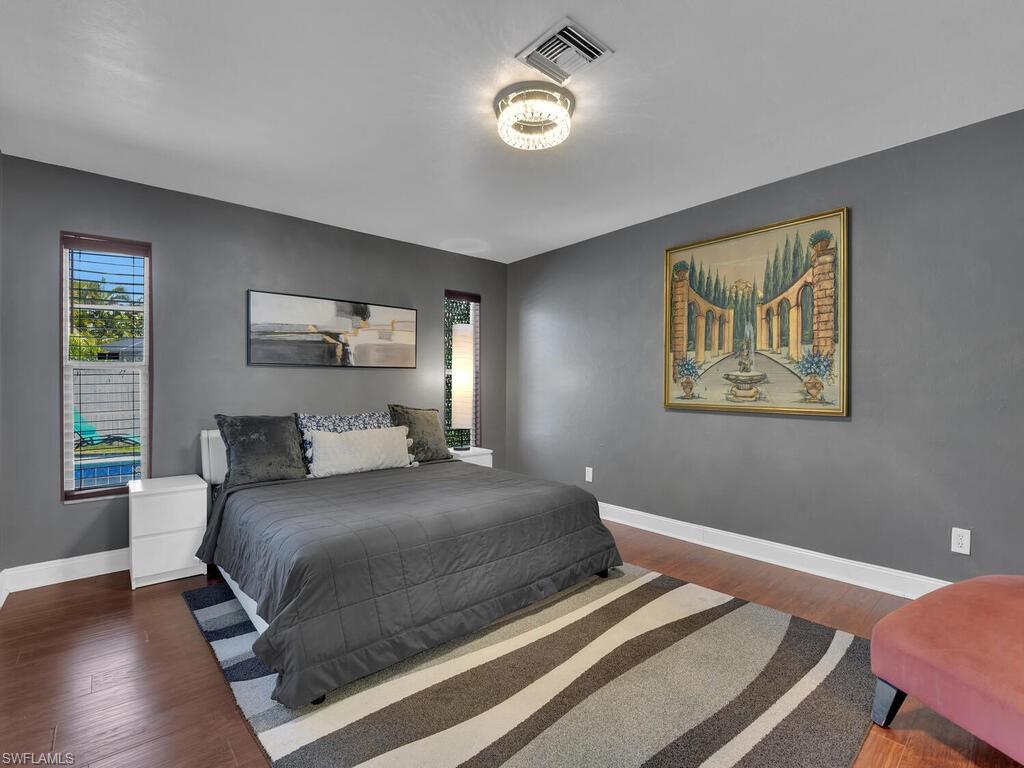 Bedroom with dark hardwood / wood-style floors