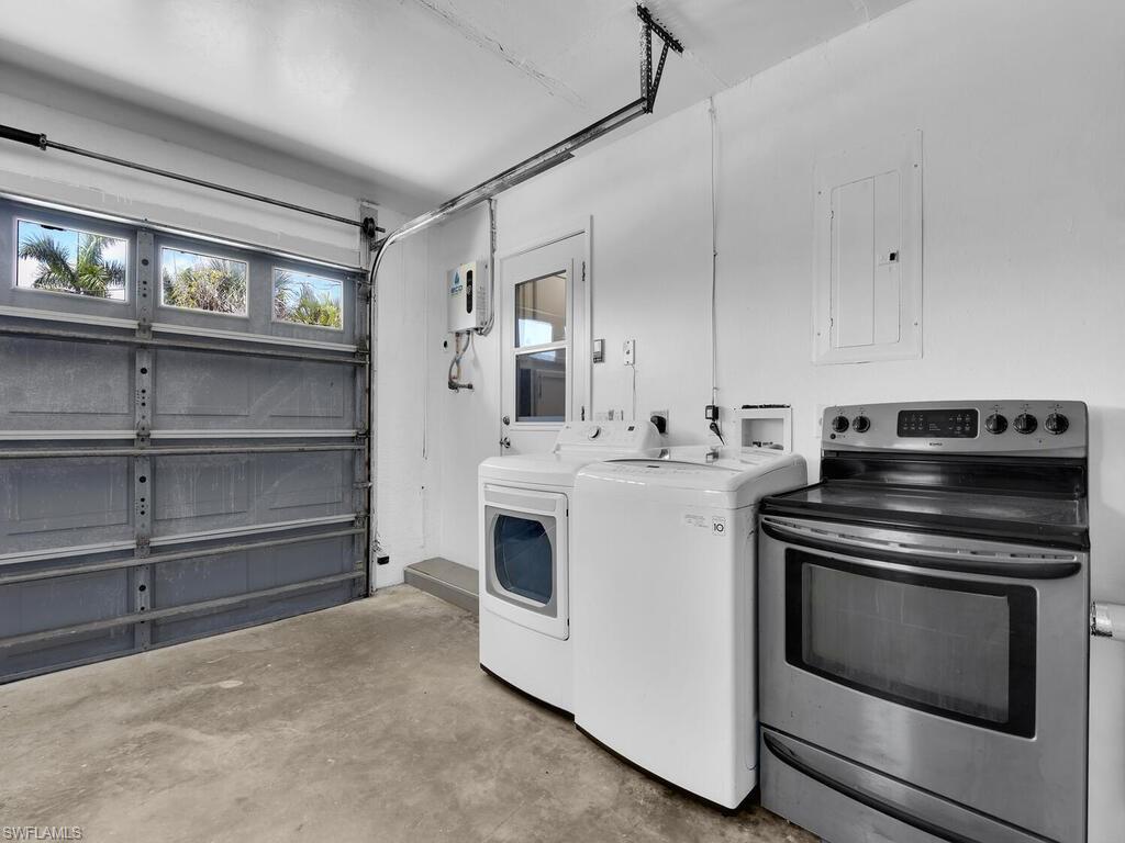 Washroom featuring independent washer and dryer and electric panel