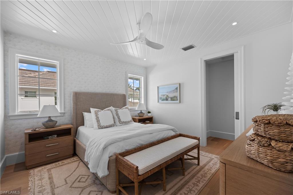 Bedroom with ceiling fan, light hardwood / wood-style flooring, and wooden ceiling