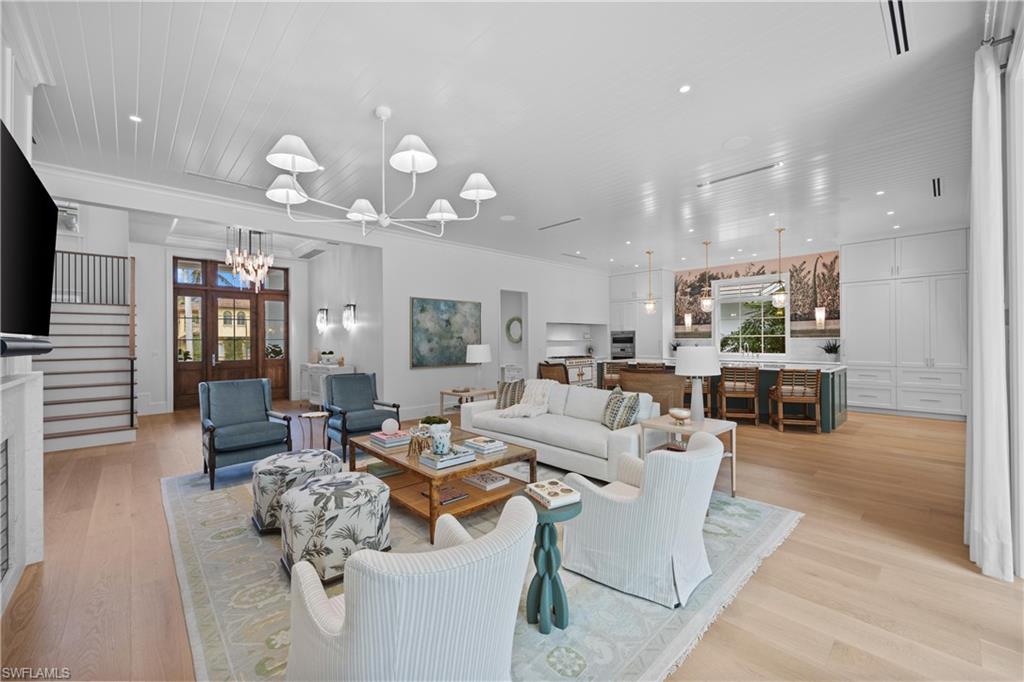 Living room with an inviting chandelier and light hardwood / wood-style floors