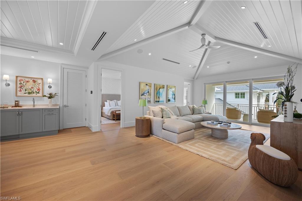 Living room featuring ceiling fan, light hardwood / wood-style floors, lofted ceiling with beams, and wood ceiling