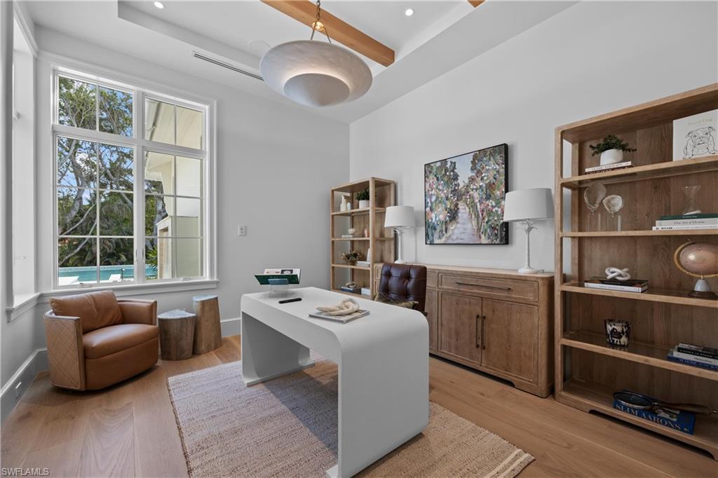 Home office with light hardwood / wood-style flooring