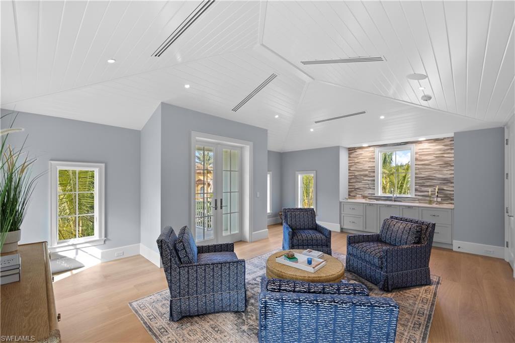 Sitting room with french doors, wooden ceiling, vaulted ceiling, and light hardwood / wood-style flooring