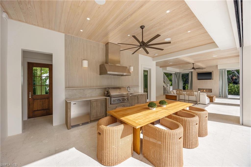 Dining room featuring wooden ceiling, a wealth of natural light, ceiling fan, and sink