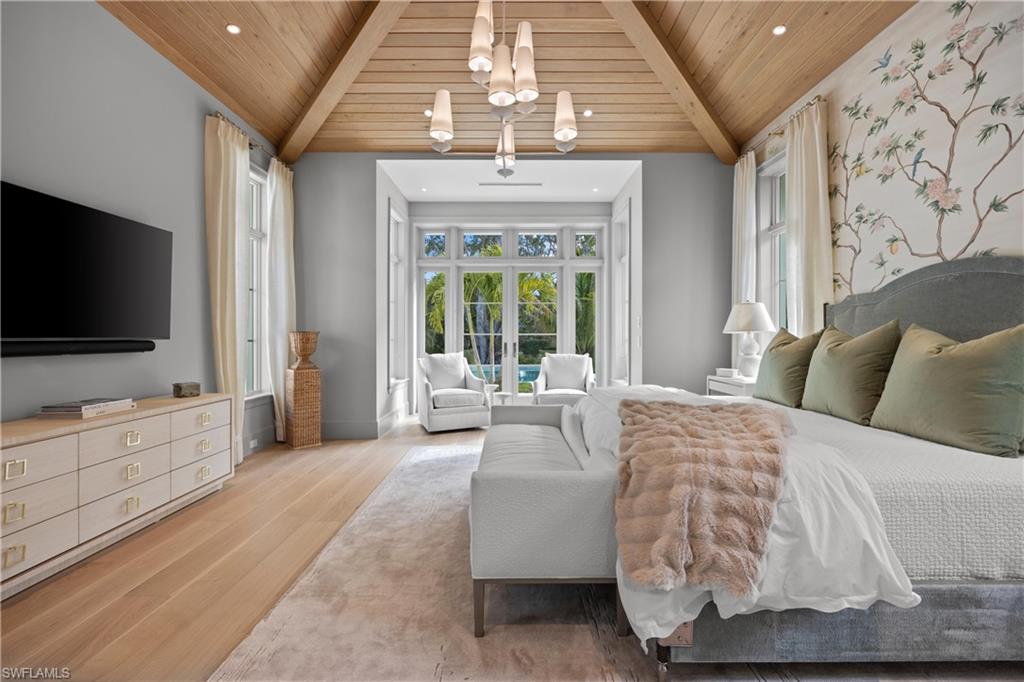 Bedroom with wooden ceiling, beamed ceiling, light hardwood / wood-style floors, and a notable chandelier