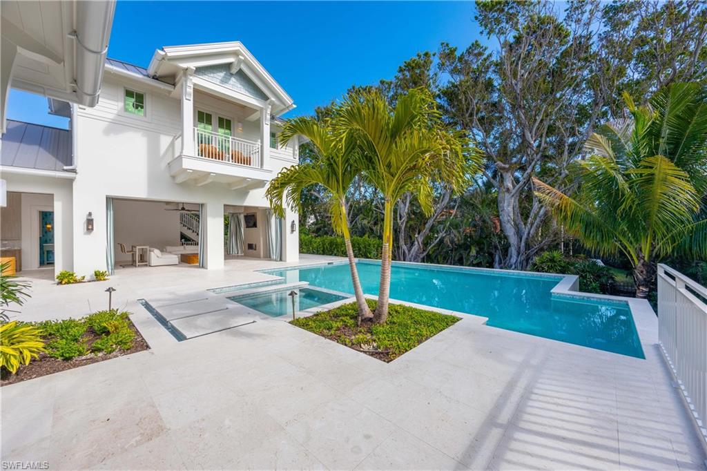View of swimming pool with ceiling fan and a patio