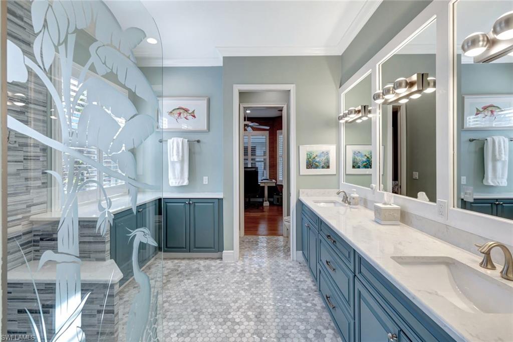 Bathroom with vanity, a healthy amount of sunlight, and ornamental molding
