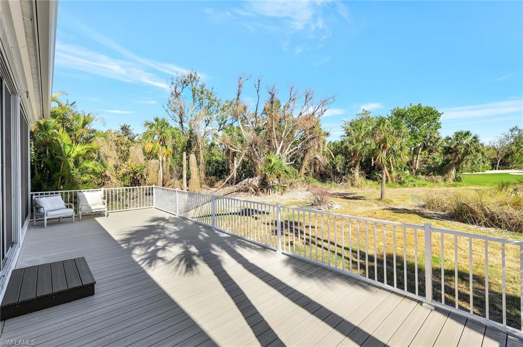 View of wooden deck off of screened rear lanai