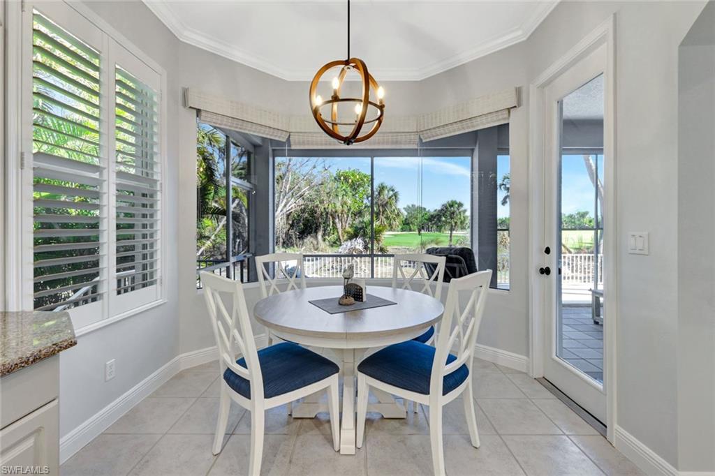 Breakfast area with a chandelier and views to patio and golf course