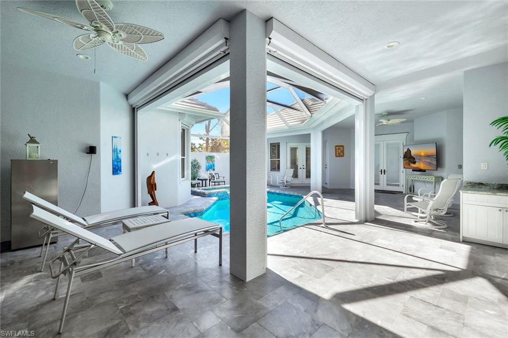 View of pool with ceiling fan