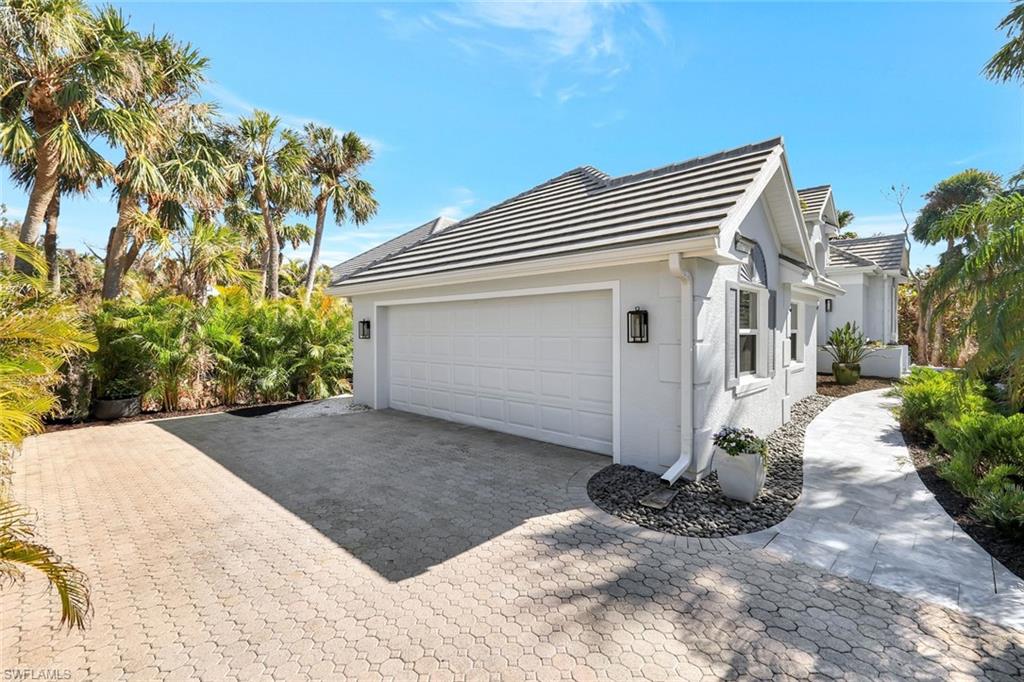 View of property exterior featuring a garage