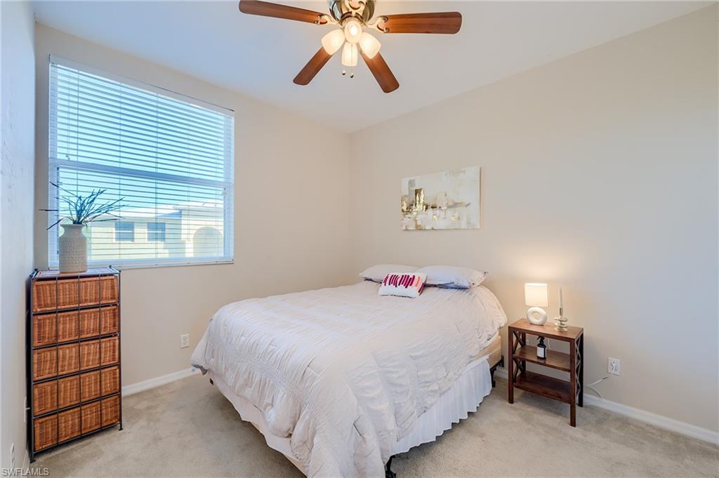 Carpeted bedroom with ceiling fan