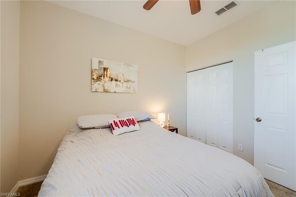 Bedroom featuring carpet flooring, ceiling fan, and a closet