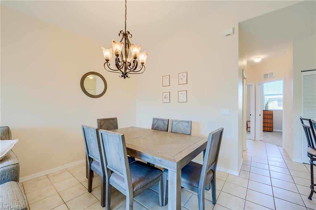 Tiled dining room with a chandelier