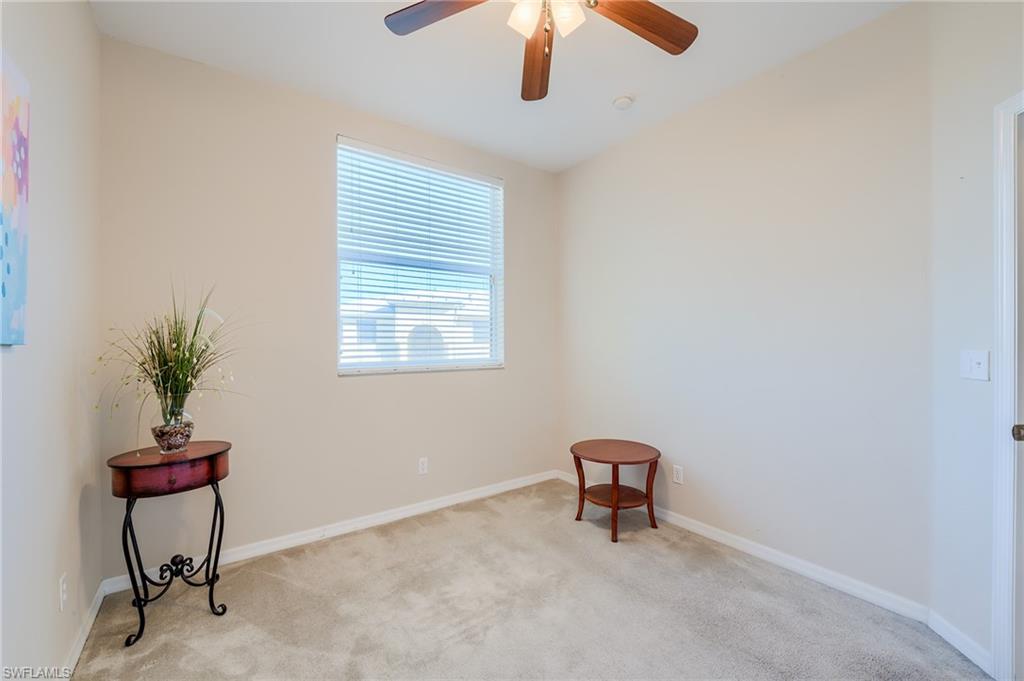 Carpeted spare room with ceiling fan