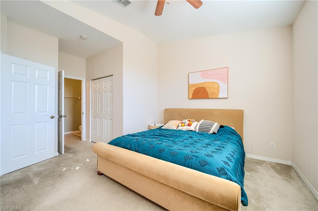 Bedroom with ceiling fan, carpet floors, and a closet